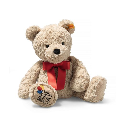 teddy bear with red bow and happy birthday written on the foot