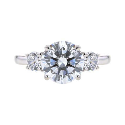 engagement ring setting with round-cut stone flanked by two round-cut side stones
