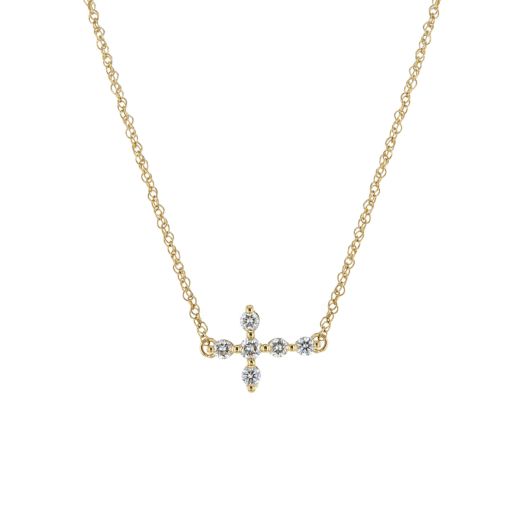 Sideways diamond cross pendant on a 14K yellow gold necklace