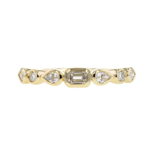 yellow gold ring with baguette diamond center, and alternating pear and round-cut diamonds on each side, all in bezel settings