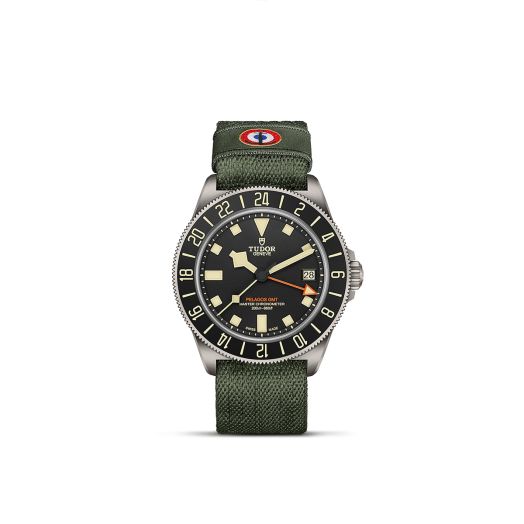 watch with green strap, black dial and light colored hands and markers