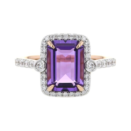 rose gold ring with amethyst centerstone set between two bezel set diamonds featuring diamond halo that extend onto band