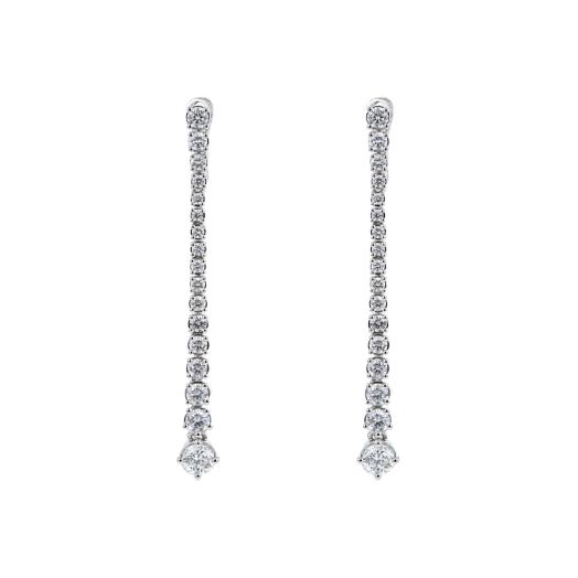 white gold diamond dangle earrings lined with diamond in a graduated fashion, from large to small and back to large diamond rounds