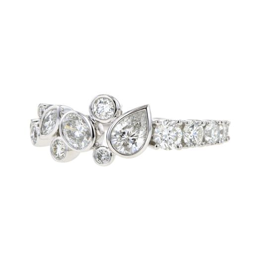 white gold ring sprinkled with array of multi-sized and multi-shaped diamonds in a unique half and half pattern. Half lined diamond rounds, half multi-sized diamonds