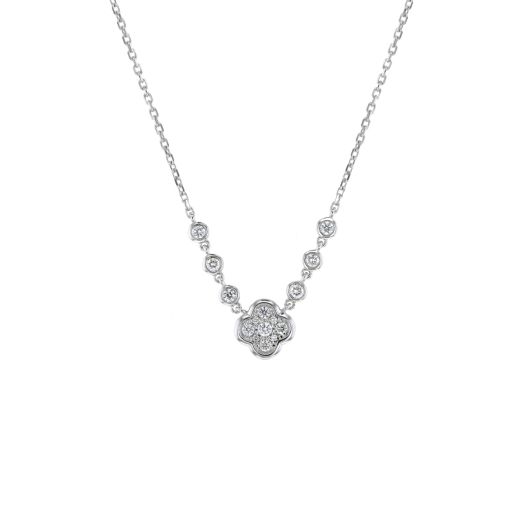 quatrefoil design adorned with multi-sized diamond hangs from white gold chain, chain showcases three round-cut diamonds in bezel settings on each side