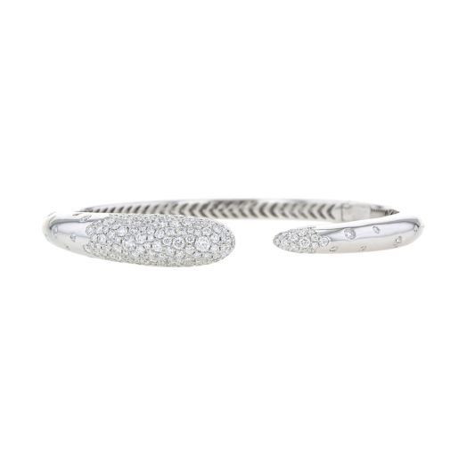 white gold open cuff with graduated design from larger to slim, covered with pave diamonds on each end and diamonds sprinkled through