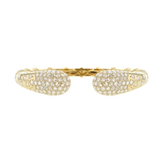 yellow gold open cuff bracelet with a cluster of diamond rounds capping each end and spreading across rest of bracelet