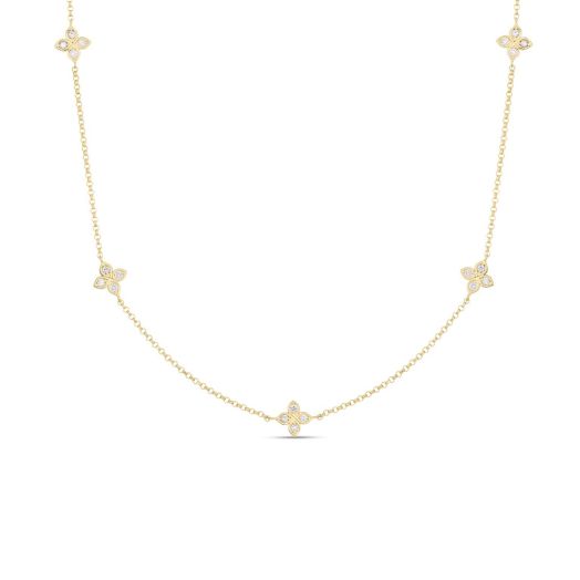 five diamond-adorned flower stations on a delicate gold chain