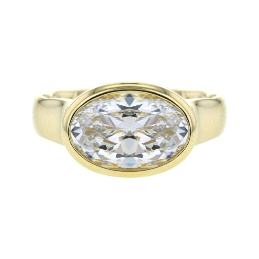 yellow gold ring with oval-cut bezel set center stone