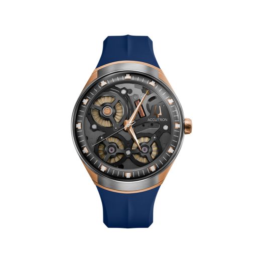 Open-work muted grey dial watch with rose gold accents and a blue rubber strap
