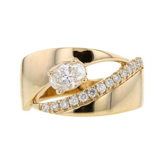 large yellow gold cigar band ring with a cutout center, featuring one oval-cut diamond on one side and the other side lined with row of pettie diamond rounds