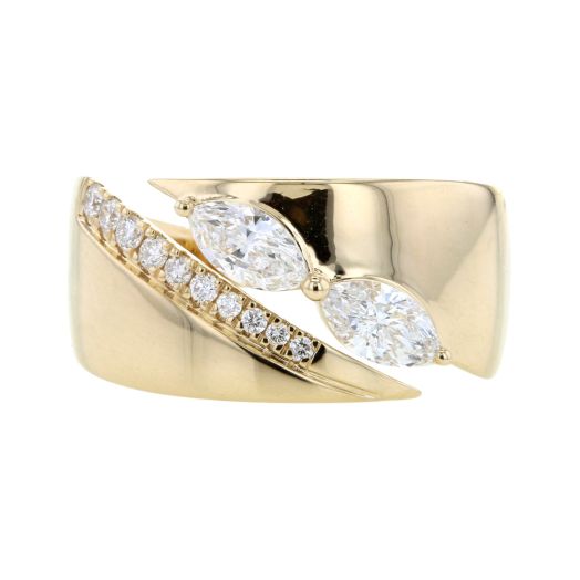 large yellow gold cigar band ring with split, one side lined with petite diamond rounds and one side lined with with two-marquise cut diamonds