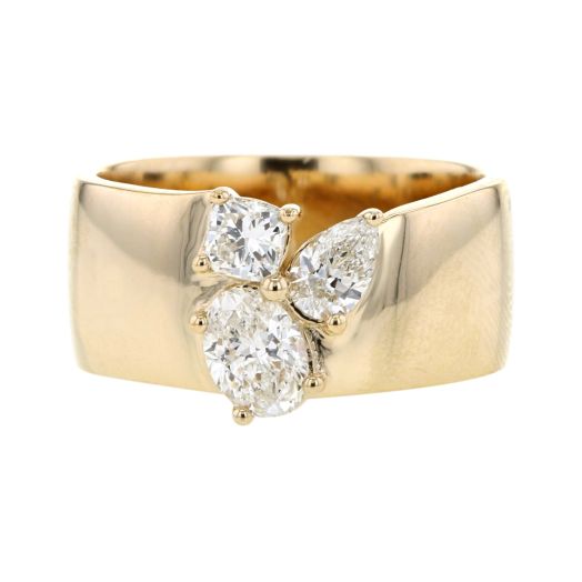 large yellow gold cigar band ring feature oval-cut, cushion-cut and pear-cut trio of diamonds