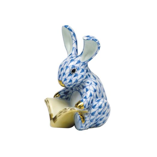 blue bunny with fishnet design reading a book with golden accents