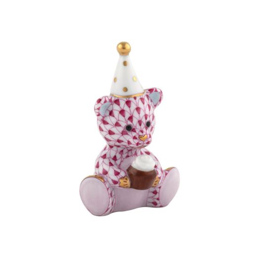 Herend porcelain Birthday Bear (Raspberry) holding a cupcake, wearing party hat, raspberry-tone fishnet pattern with gold accents