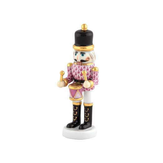 Herend porcelain Nutcracker Drummer (Raspberry) holding a drum, wearing festive uniform, raspberry-tone fishnet pattern with gold accents