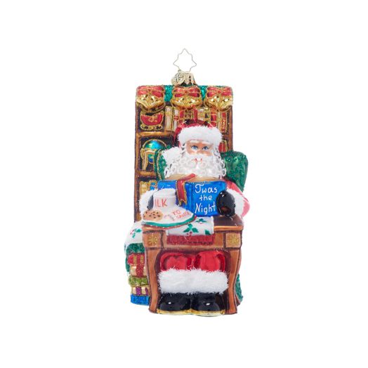 ornament featuring santa reading a book with milk and cookies