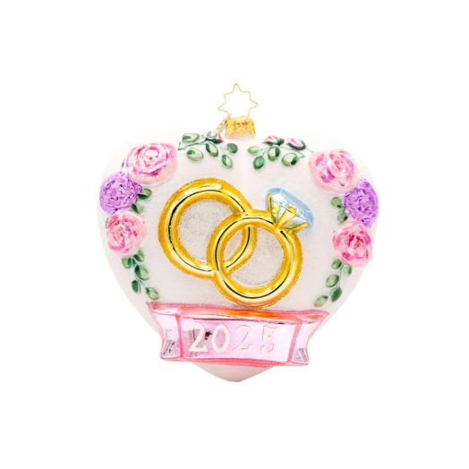 Heart ornament showcasing wedding rings and the year 2025