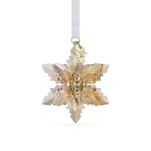 champagne colored 3d snowflake ornament suspended from white string