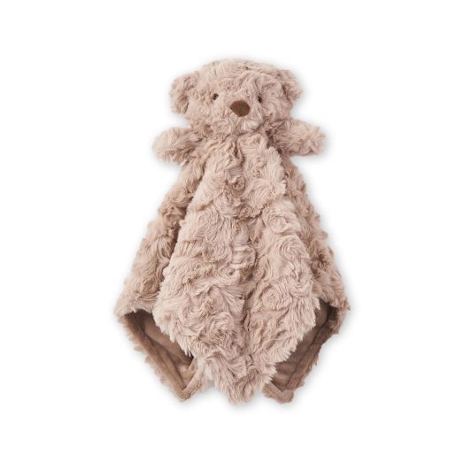 light colored blanket with fuzzy accents, accented with a stuffed bear top