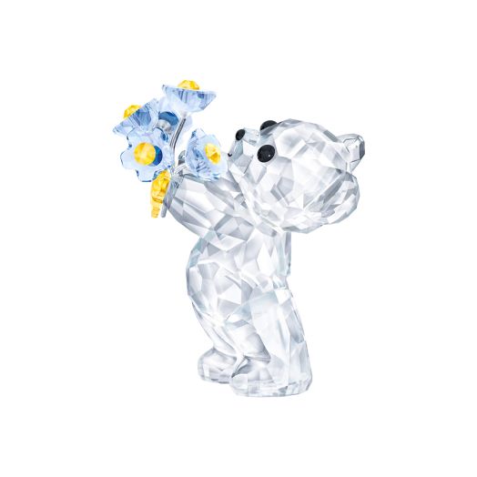 Crystal bear figurine holding a bouquet of flowers
