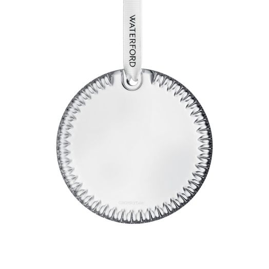 crystal disc ornament suspended from white ribbon