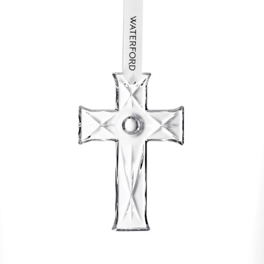 crystal cross ornament suspended from white ribbon