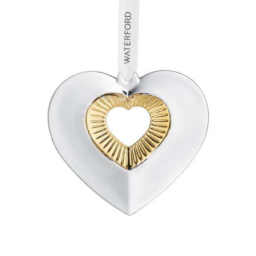 white heart ornament with golden cut out center suspended from white ribbon