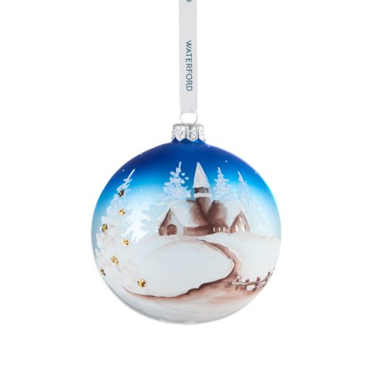 circle ornament with winter scene suspended from white ribbon