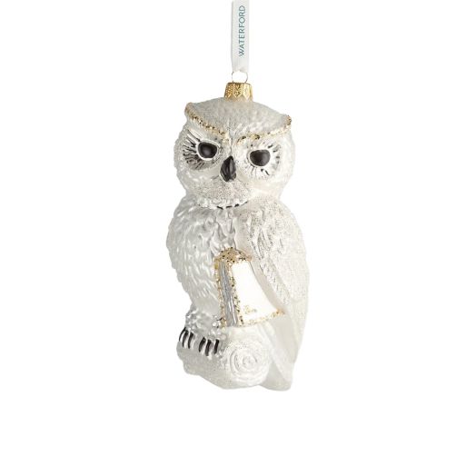 white owl ornament hung from white ribbon