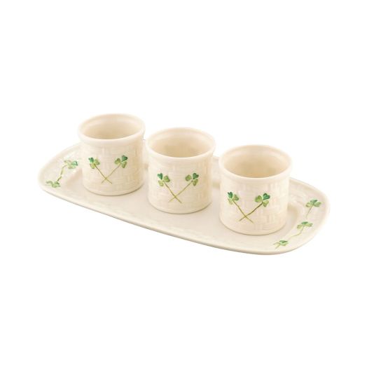 three small white cups with shamrock details set on a white tray also with shamrock details