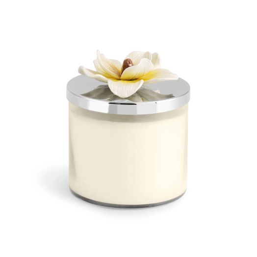 Candle featuring a white magnolia blossom lid on a glass jar with soy wax, nickelplate, and enamel accents.