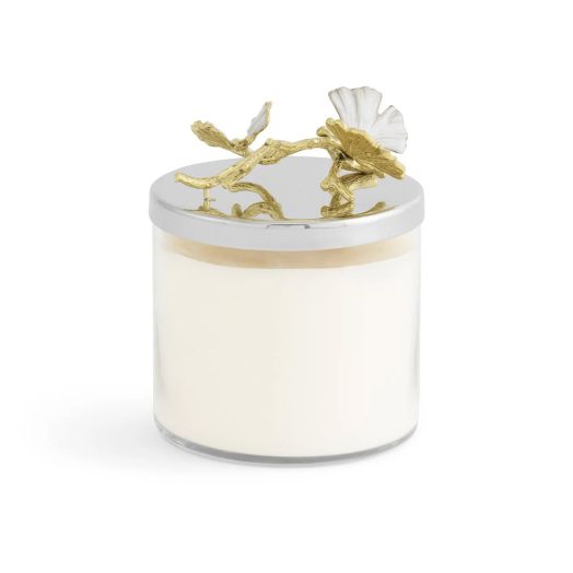 Candle featuring a white magnolia blossom lid on a glass jar with soy wax, nickelplate, and enamel accents.