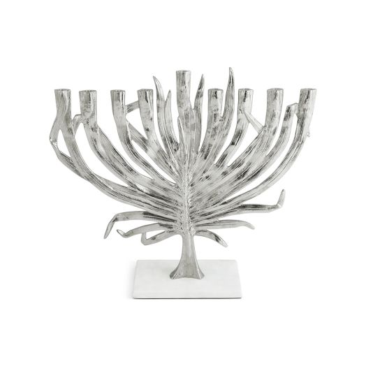 silver tone menorah with palm leaves set on white base