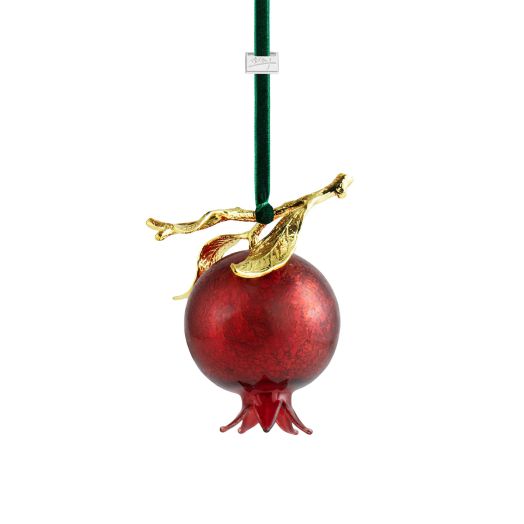 red pomegranate ornament with golden leaf suspended from green velvet string