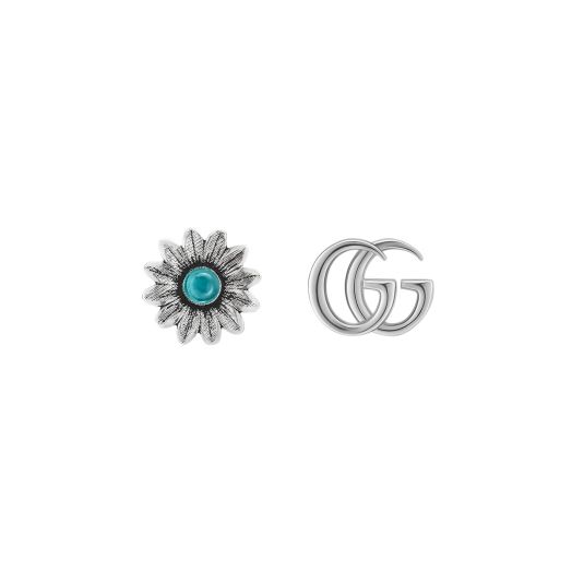 Gucci stud earrings, one is a flower and the other is the iconic gg logo