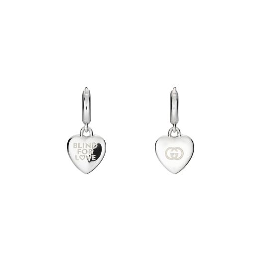 small silver hoop earrings with heart-shaped dangles featuring gucci's signature emblematic motifs