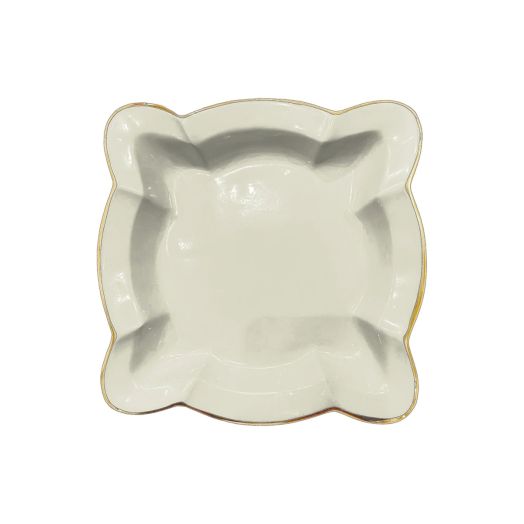 cream colored napkin holder with unique scalloped edges and golden rim